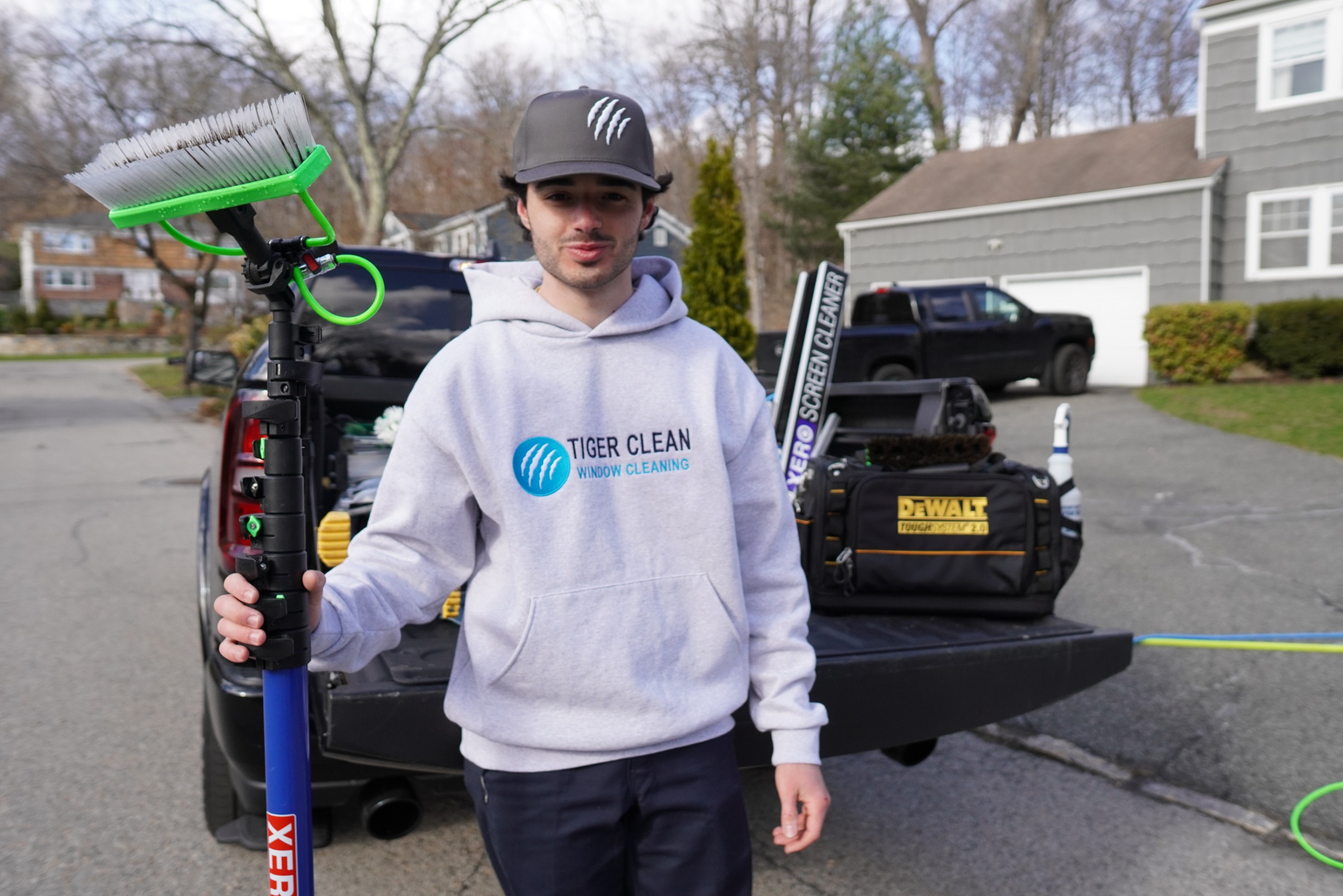 Tiger Clean technician with window cleaning equipment