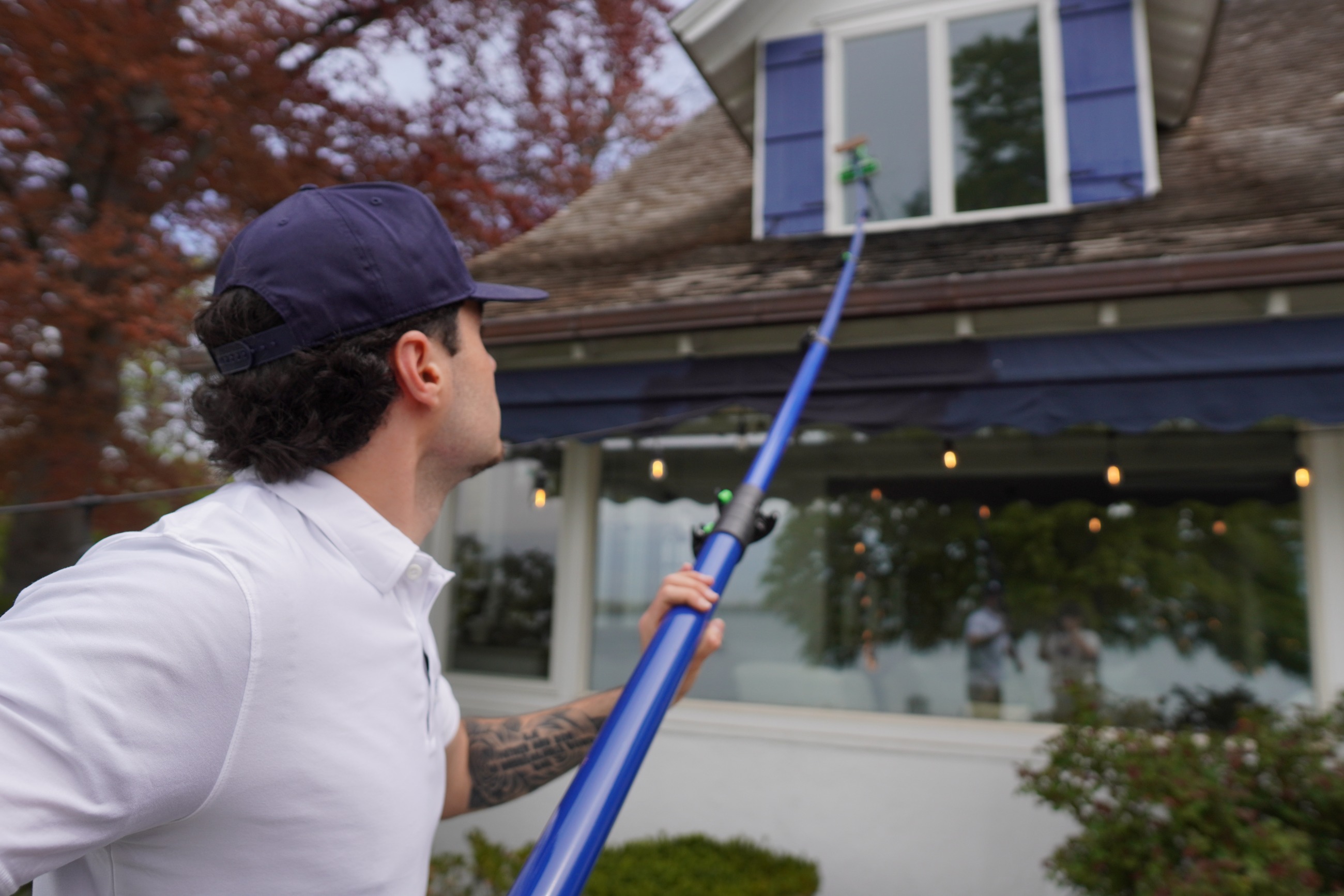 Tiger Clean technician cleaning windows with a water-fed pole