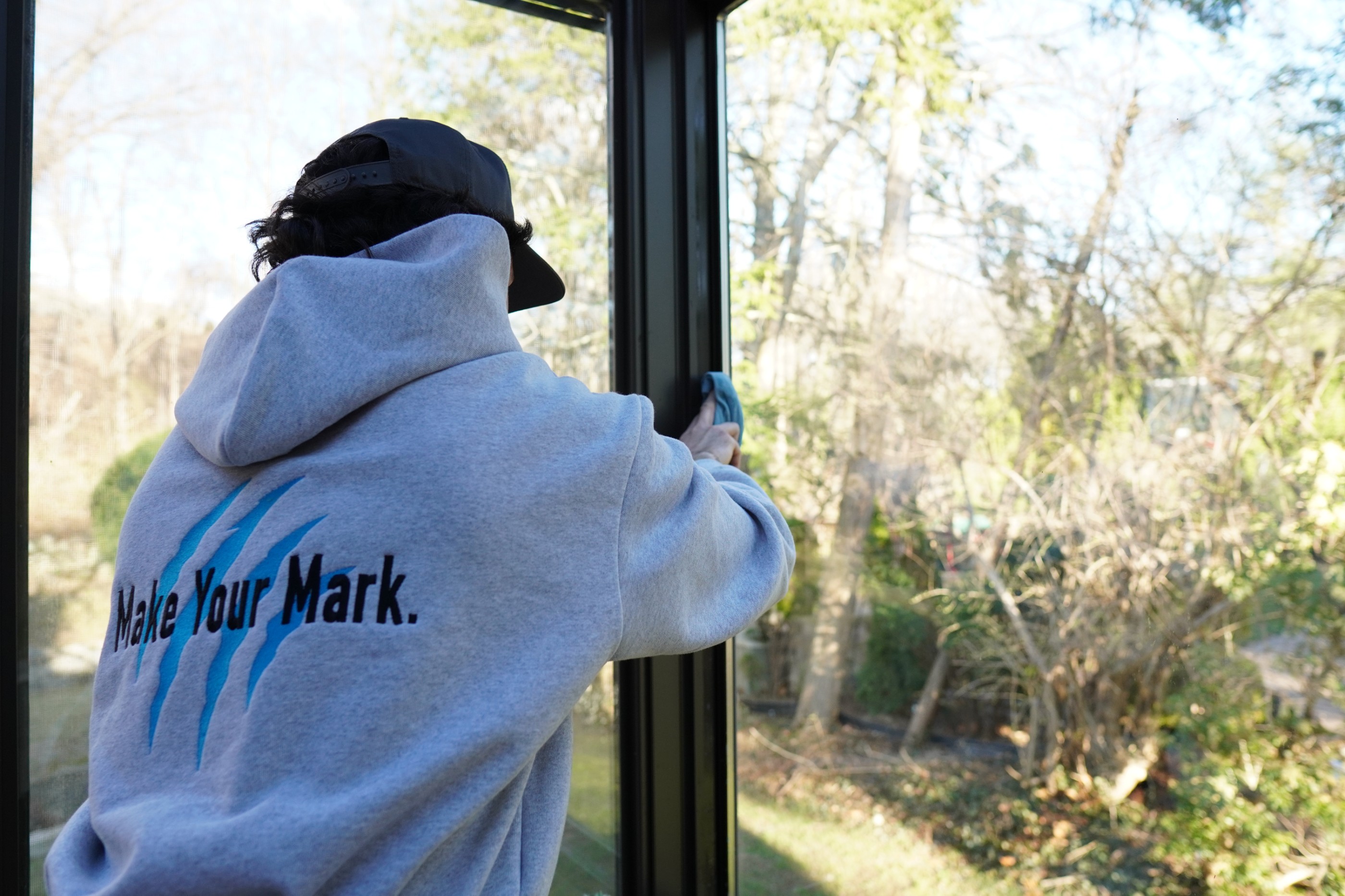 Tiger Clean technician cleaning a window screen
